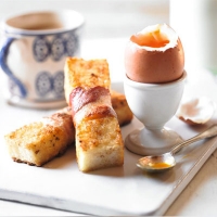 Easter eggs with crispy egg & bacon soldiers